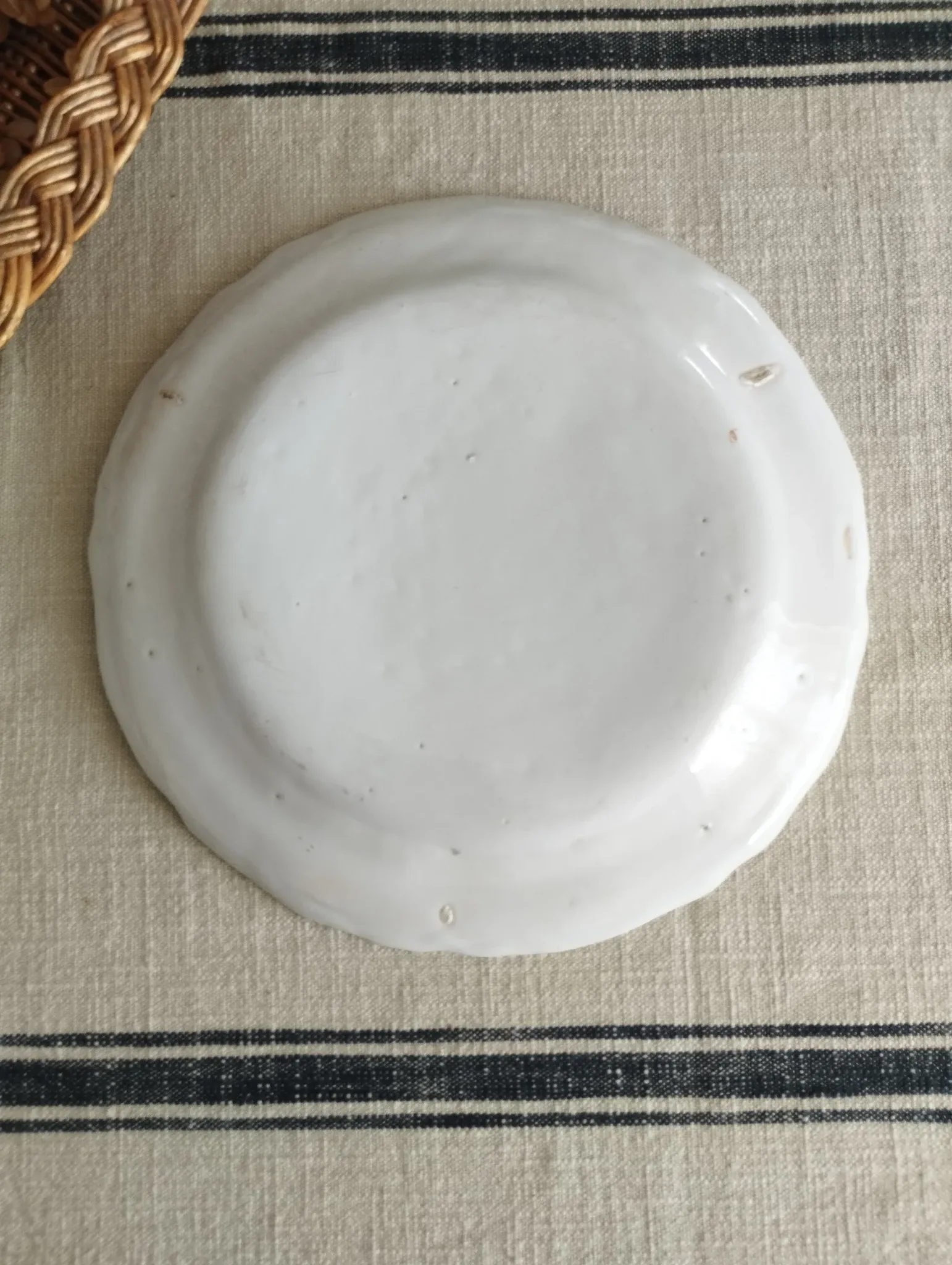 Pair of antique plates with a bird of paradise design in the style of Moustiers.
