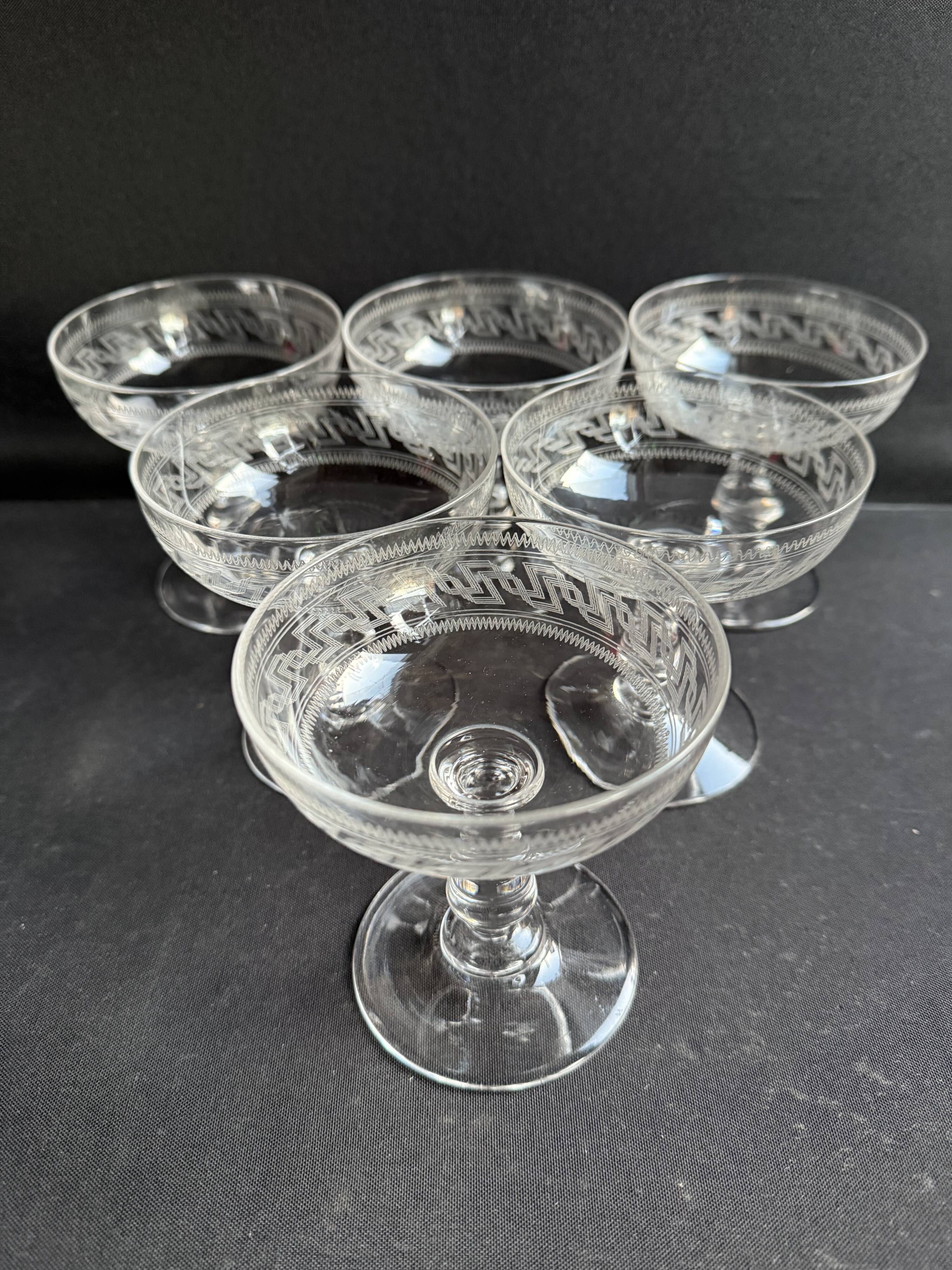 6 Baccarat champagne coupes with Greek engraving, slanted.