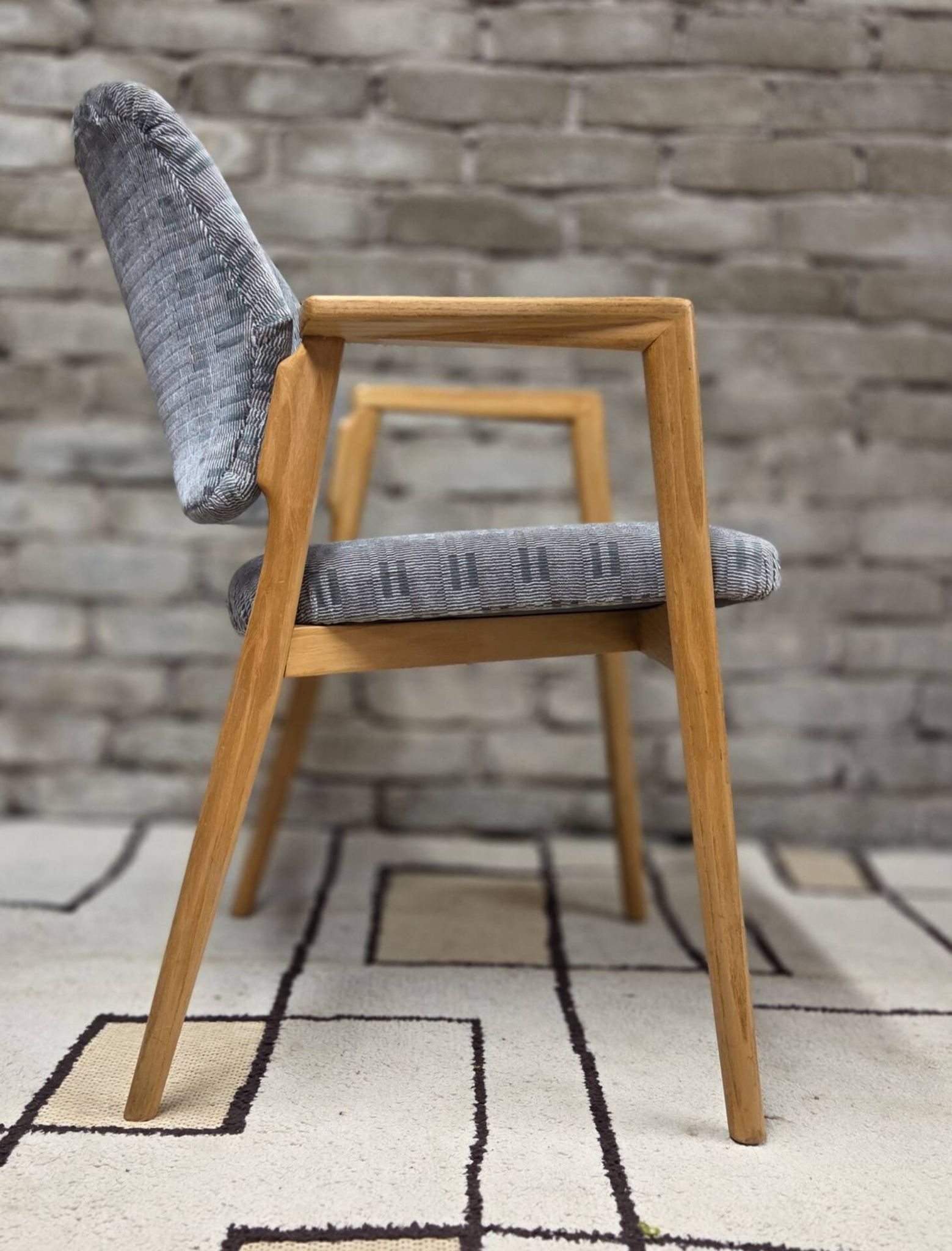 Vintage armchair from the 60s/70s in wood and grey fabric – with armrests.