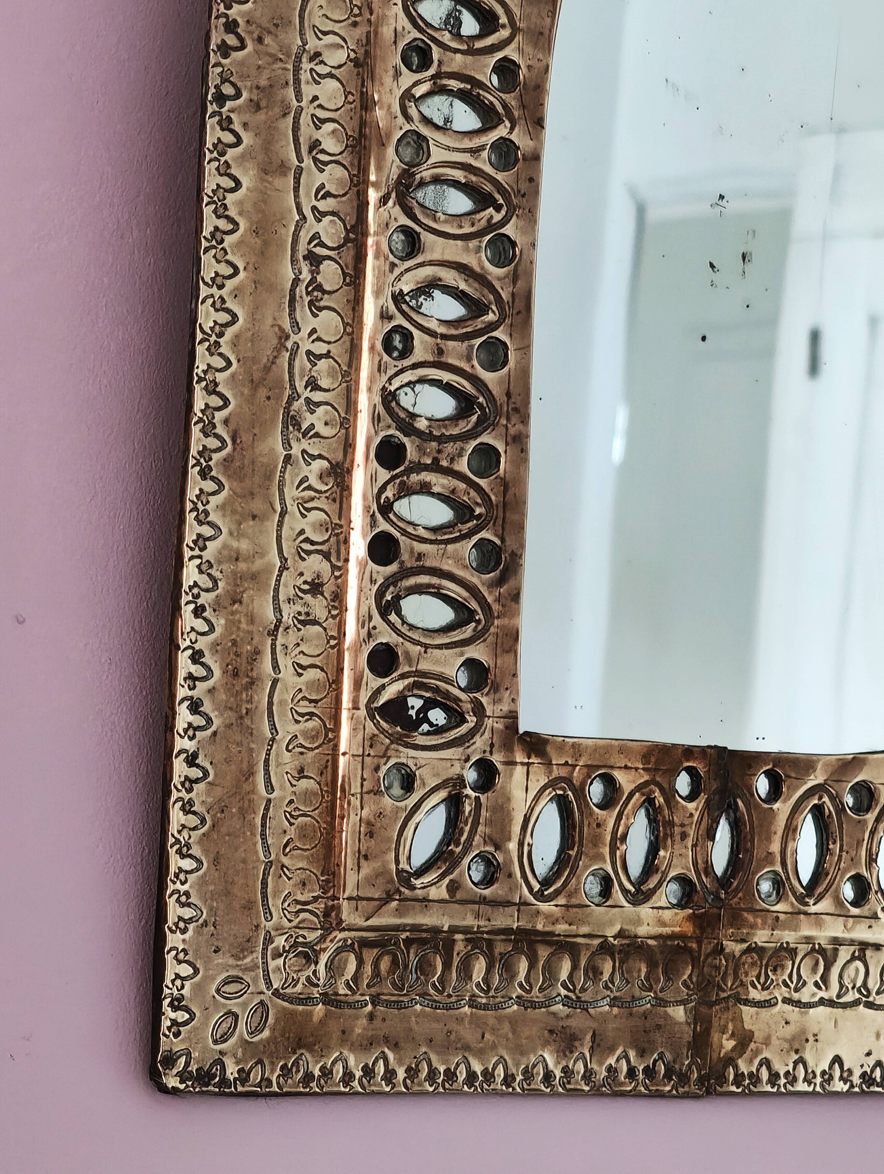Small golden metal mirror in oriental style.