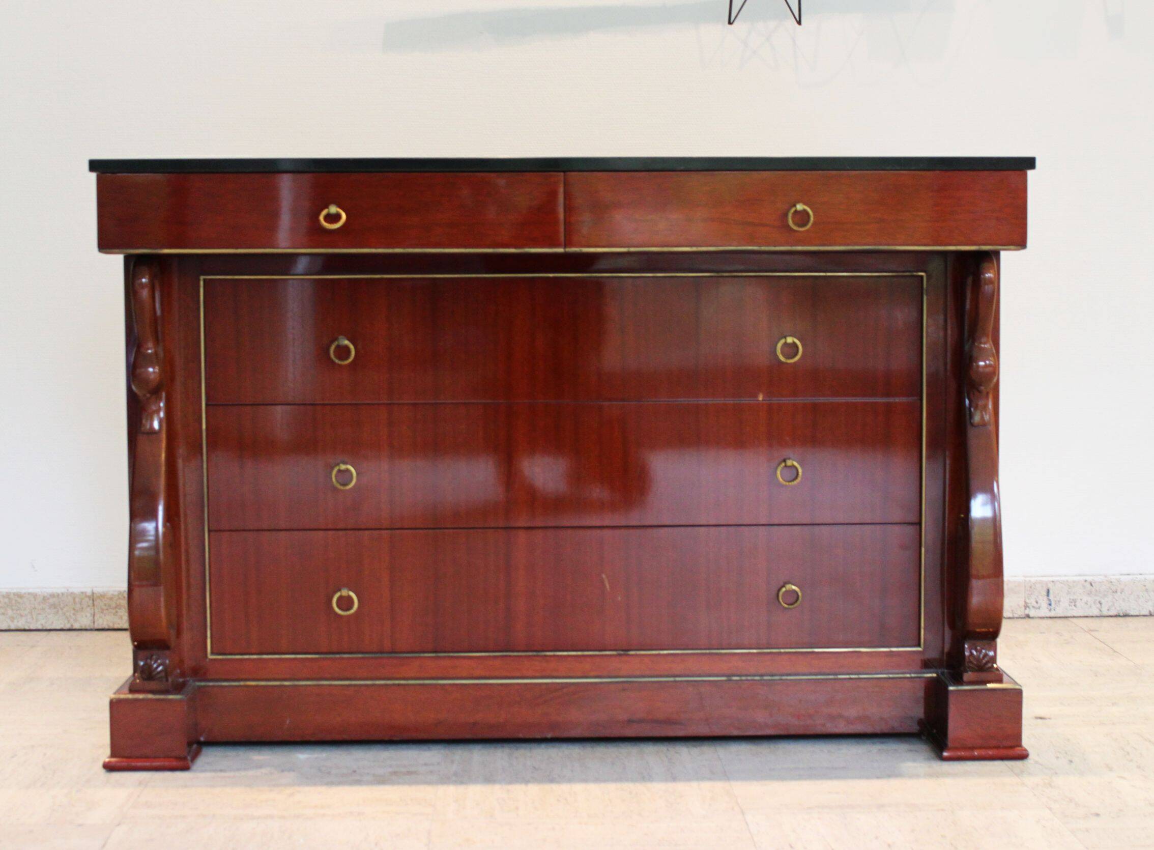 Mahogany “swan neck” chest of drawers, Empire style, 19th century.