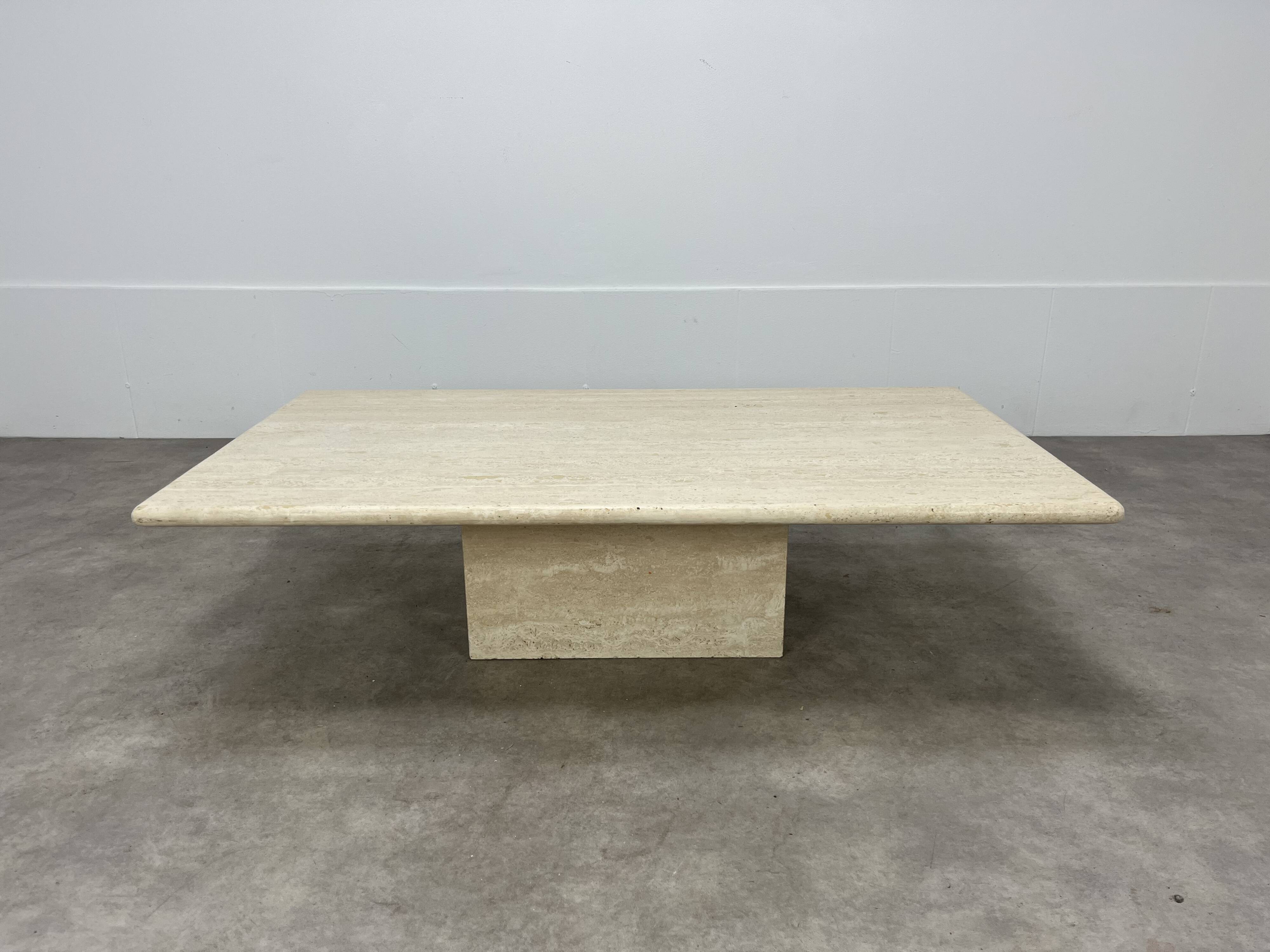 Rectangular travertine coffee table with central leg