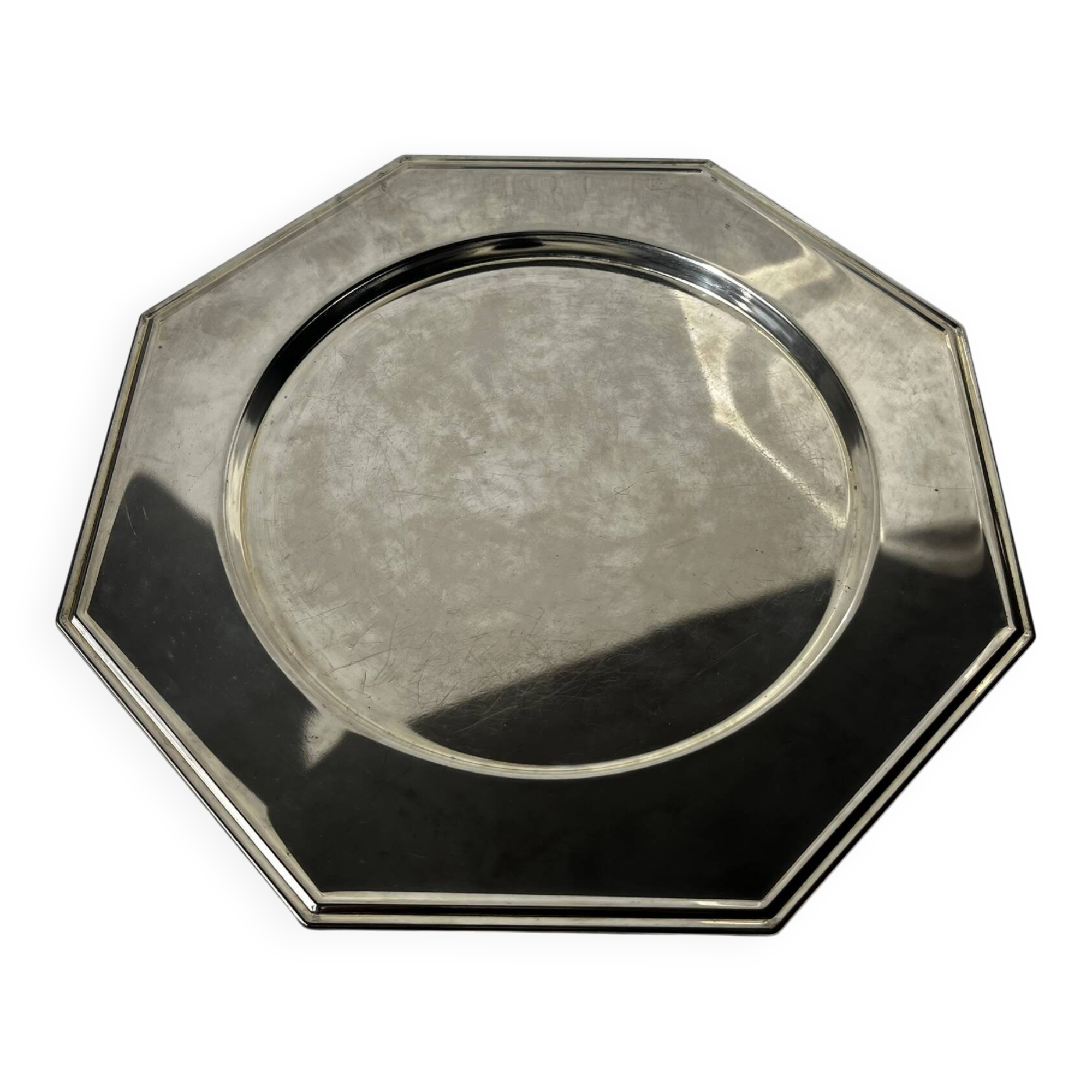 Many octagonal presentation plates in silver-plated metal.