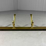 Gold coloured aluminium wall coat rack 1960’s
