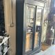Black painted wardrobe with two glass doors and an interior sideboard.