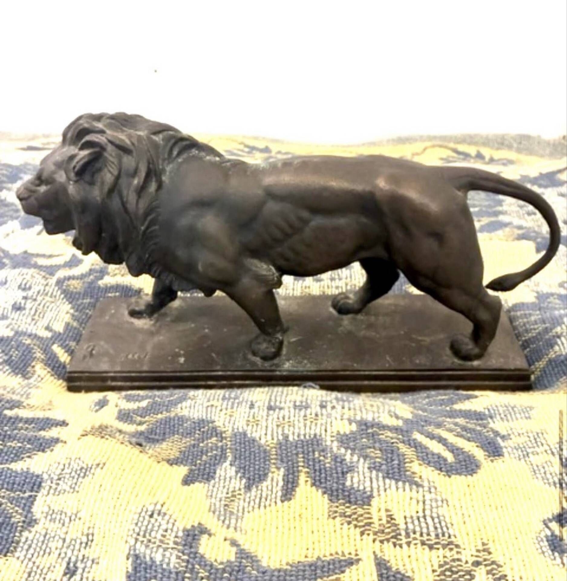 Bronze lion in motion with a brown patina, signed barye.