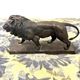 Bronze lion in motion with a brown patina, signed barye.