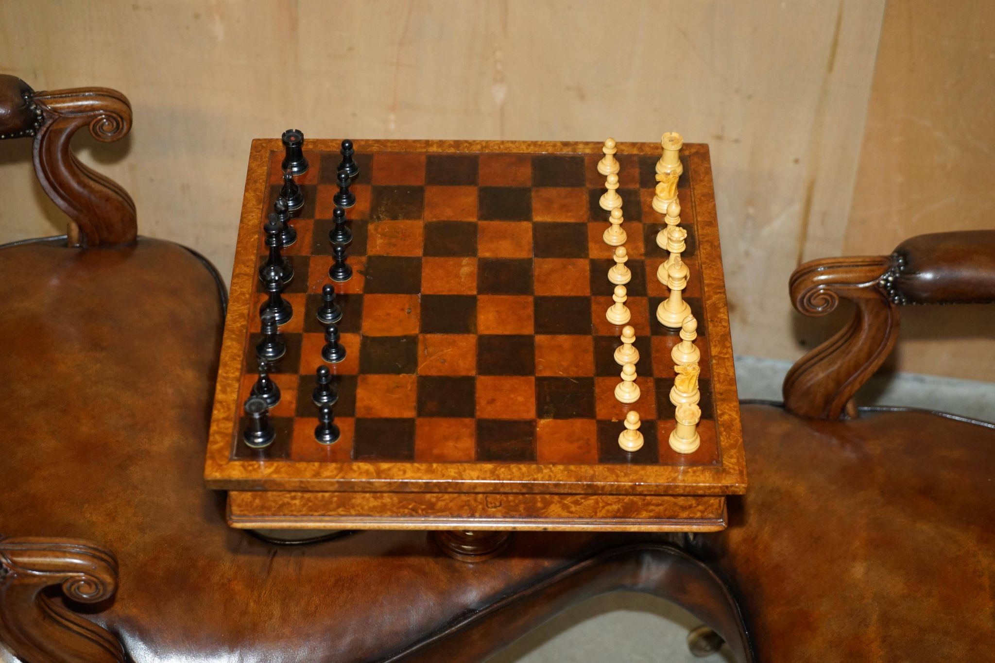 High Victorian leather tête-à-tête canapé with a walnut burr chessboard.