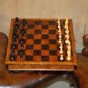 High Victorian leather tête-à-tête canapé with a walnut burr chessboard.