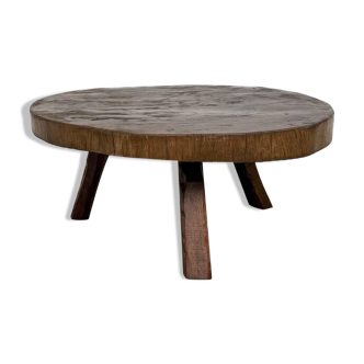 Brutalist coffee table in solid teak, monolithic slab, tripod base.