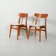Pair of vintage teak chairs with a curved backrest