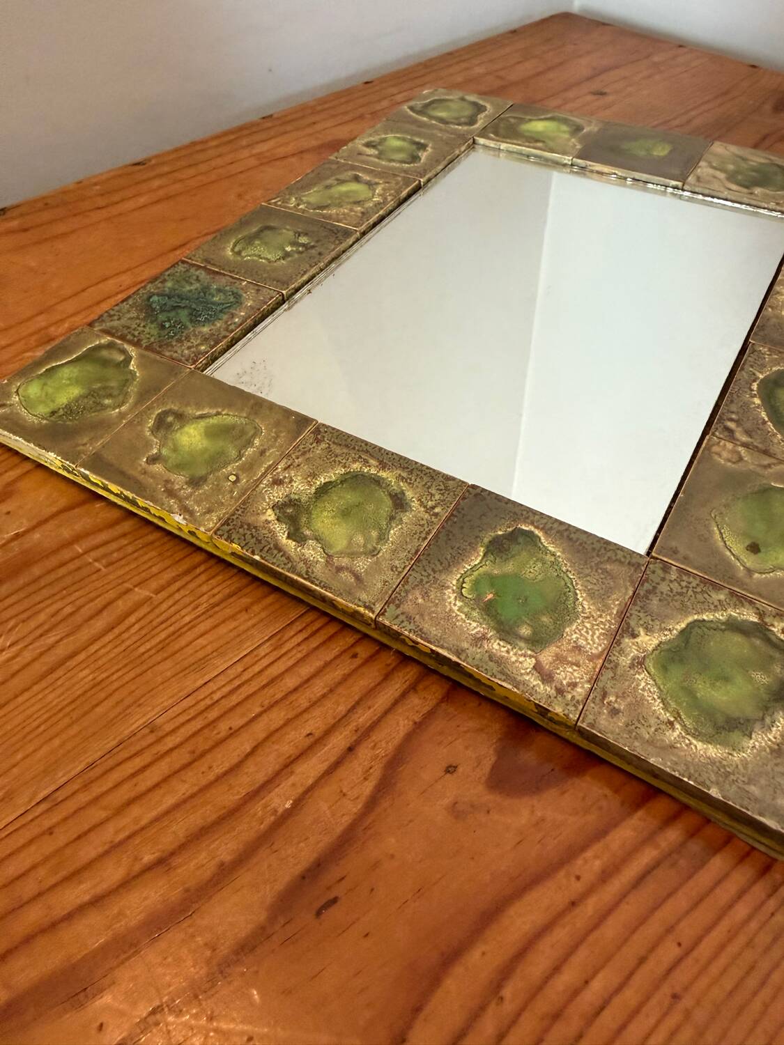 Vintage 1960s green and brown glazed ceramic mirror.