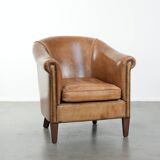 Characterful club chair made of sheepskin leather with light cognac colours