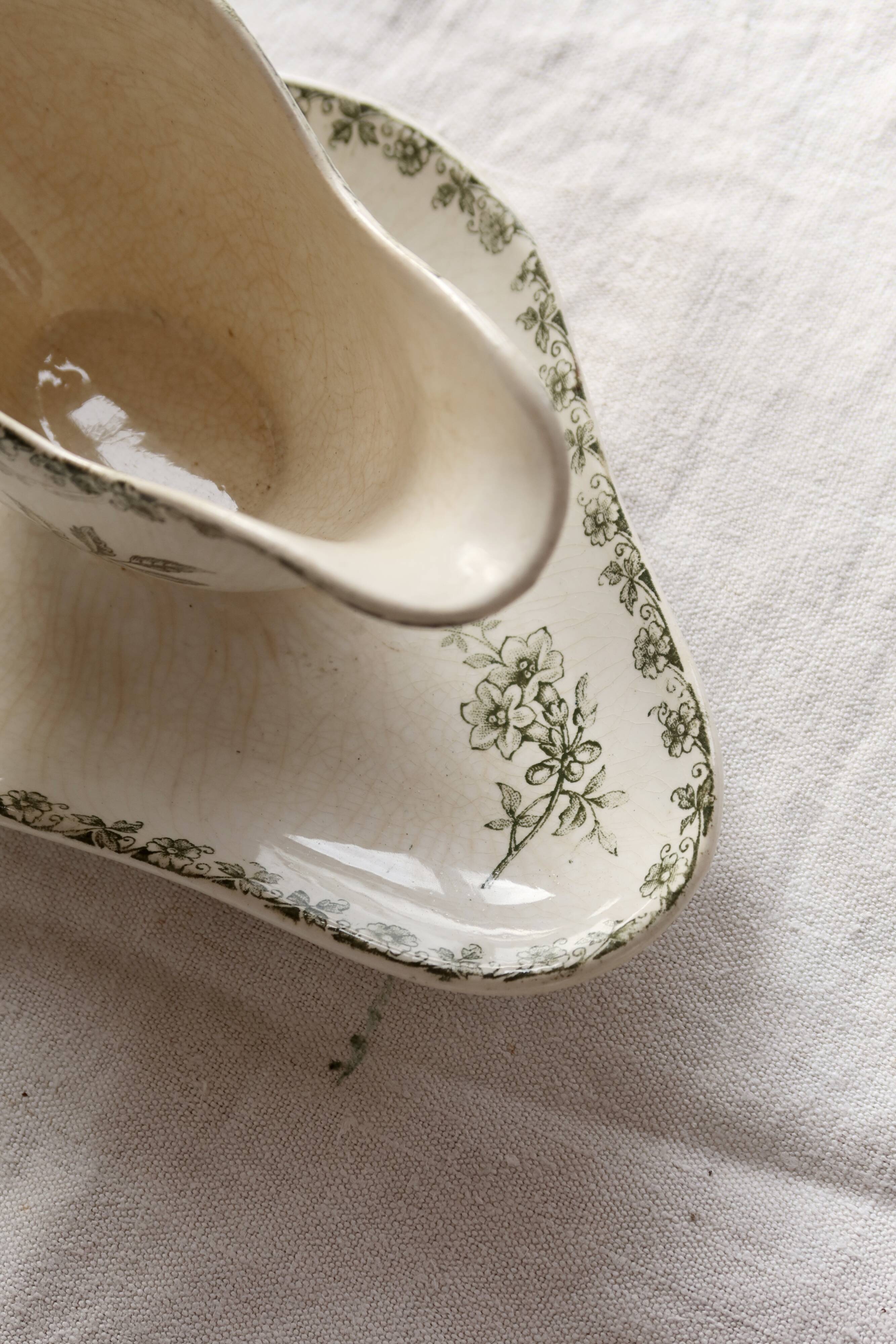 Antique sauce boat, ironstone, ivory with green floral and butterfly decoration.