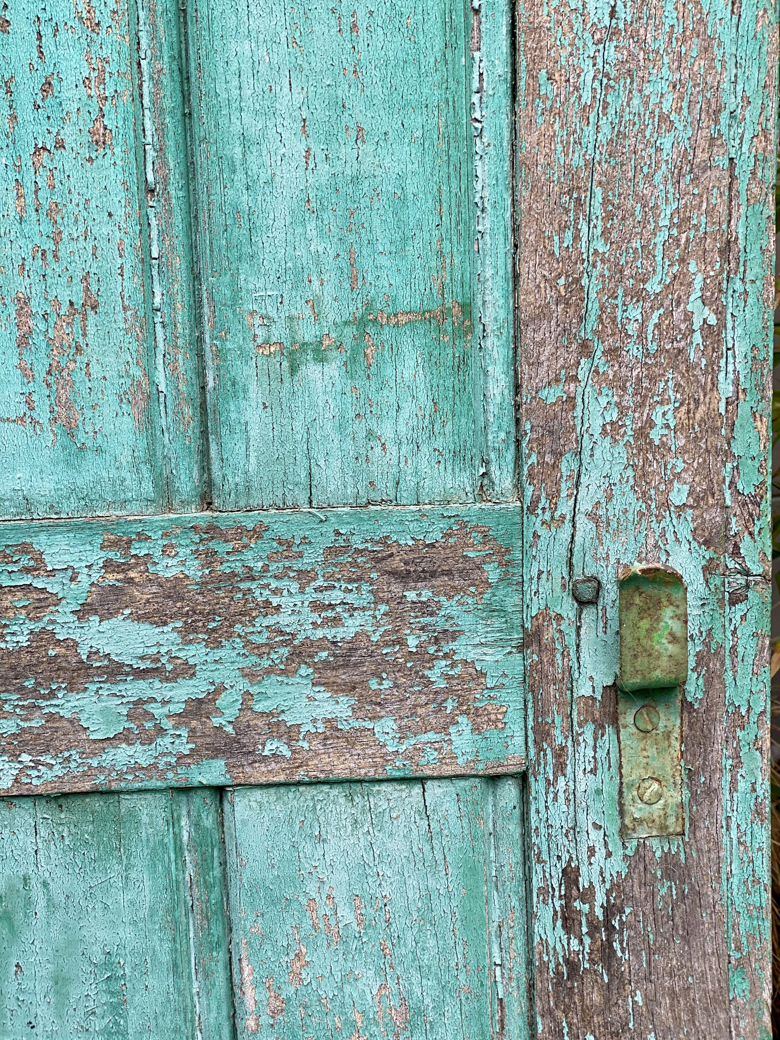 Pair of old wooden shutters green mint color