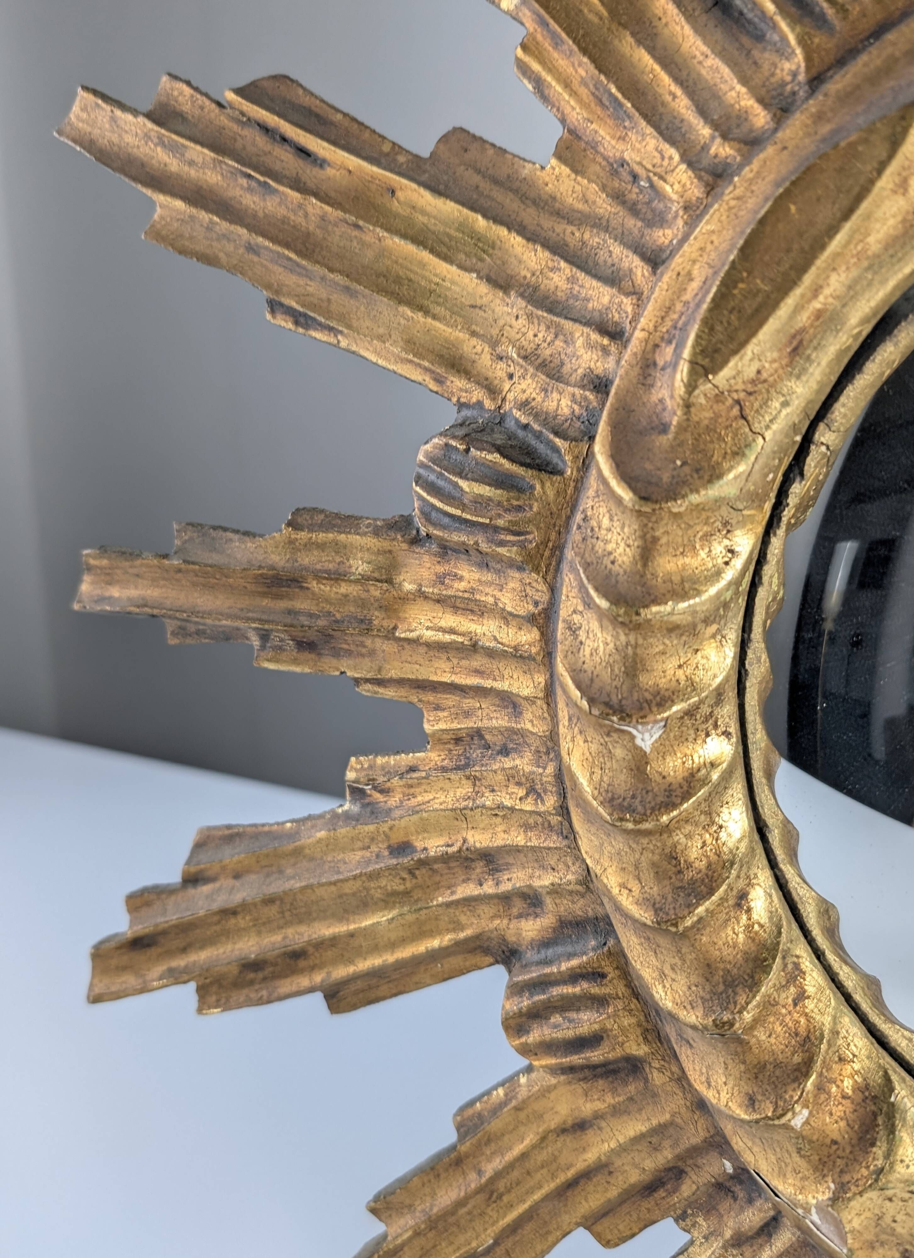 Convex sunburst mirror in carved and gilded wood, 1950s