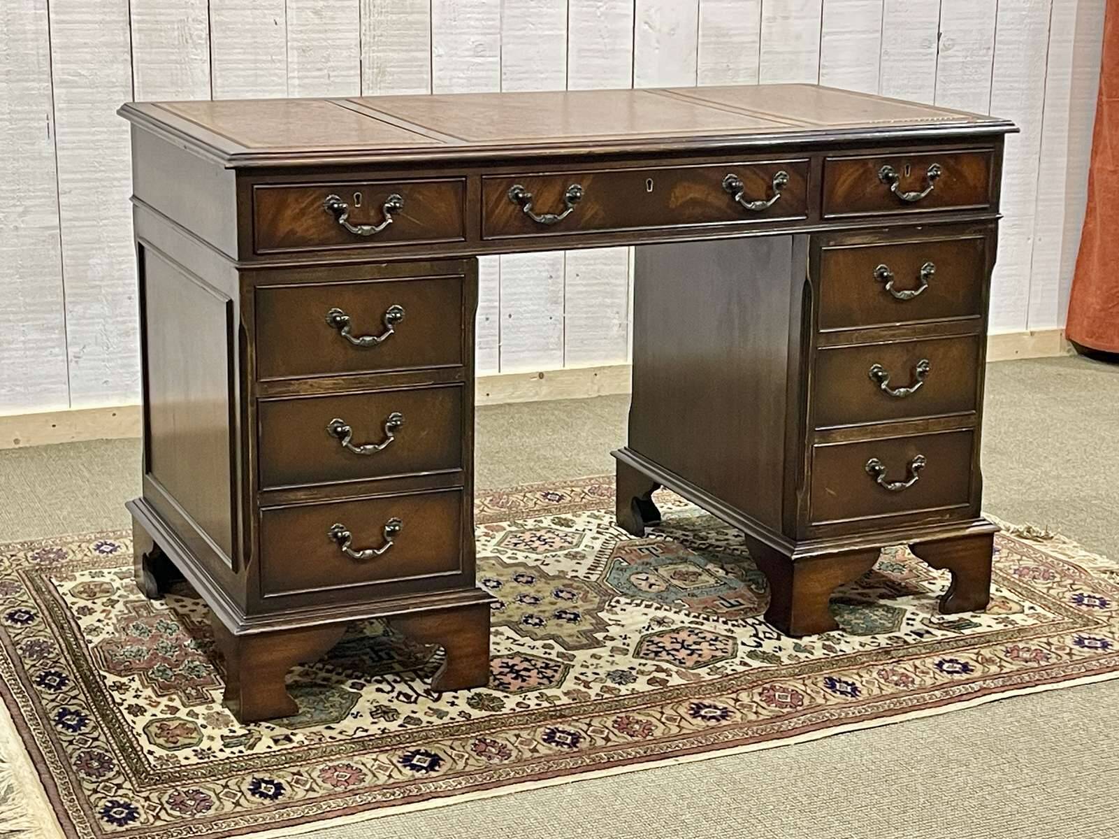 English mahogany pedestal desk with leather top from the 1950s