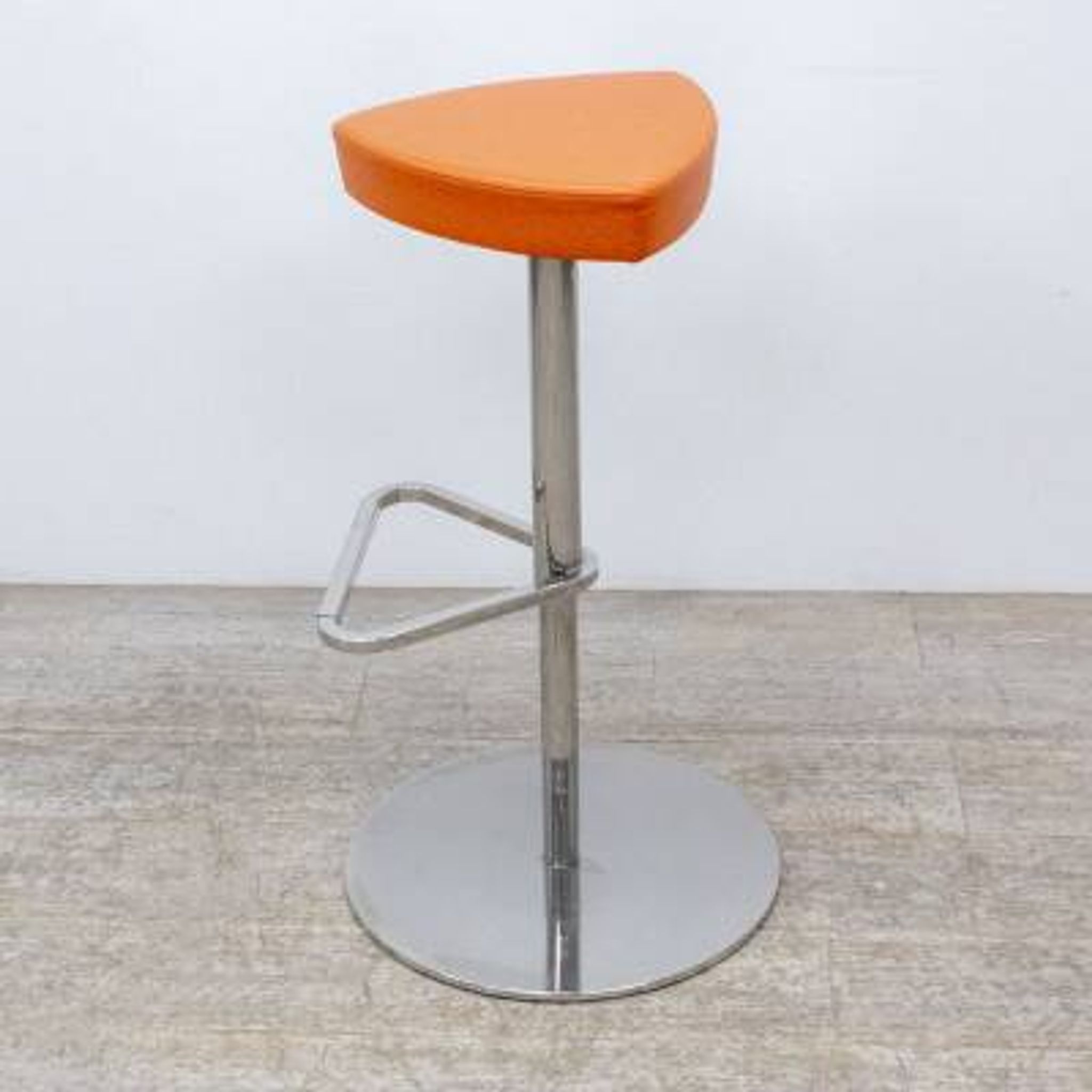 Adjustable orange swivel bar stool