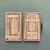 2 old small wooden tables that fold into suitcases