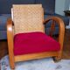 Ancien fauteuil bas colonial style Art Déco en bois.