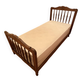 1 bed with a wooden frame and mattress