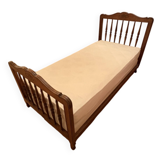 1 bed with a wooden frame and mattress
