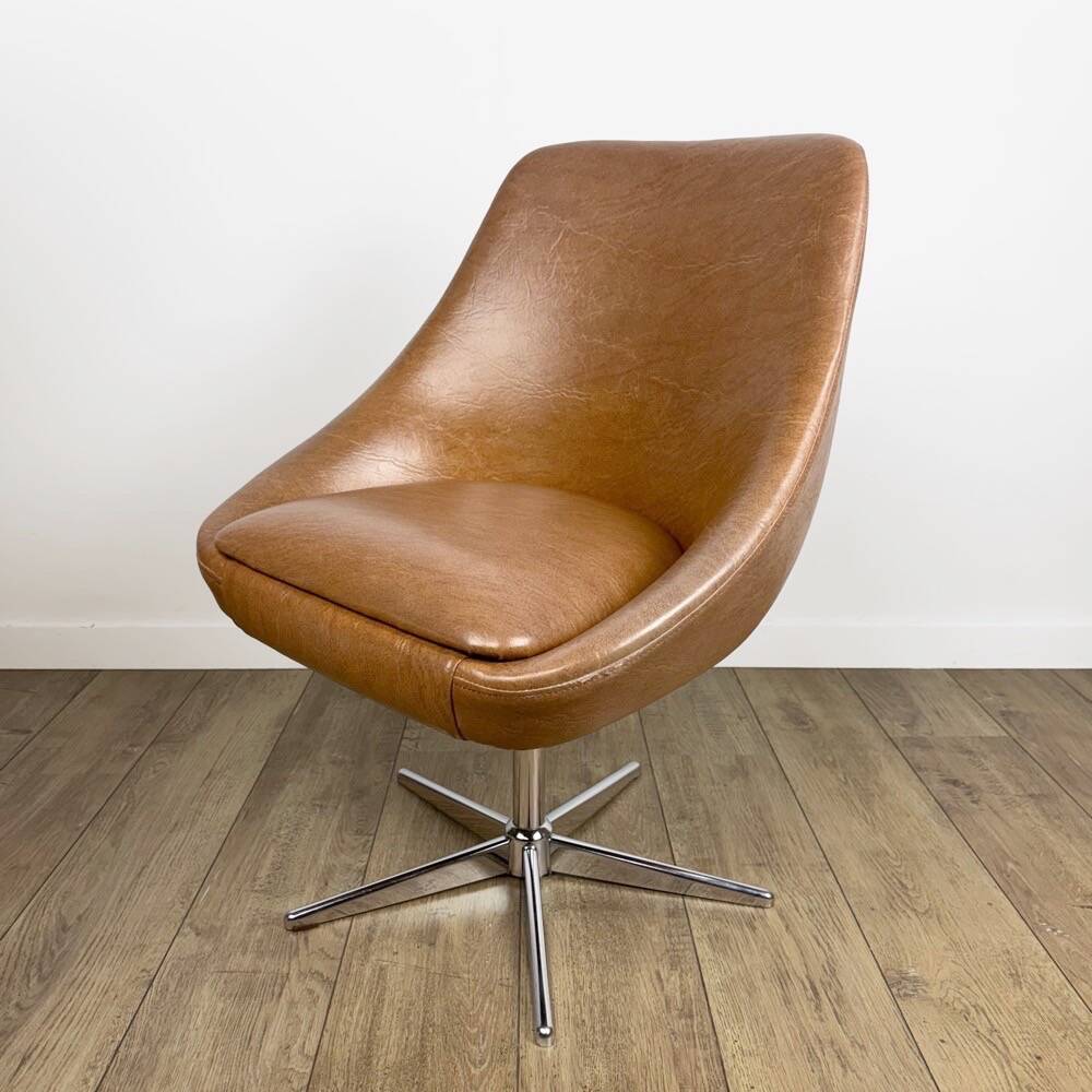 1970s swivel chair with faux leather shell and chrome.