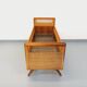 Vintage oak and rattan baby cot from the 1960s.