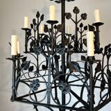 Lustre with 12 lights in wrought iron decorated with clovers and foliage.