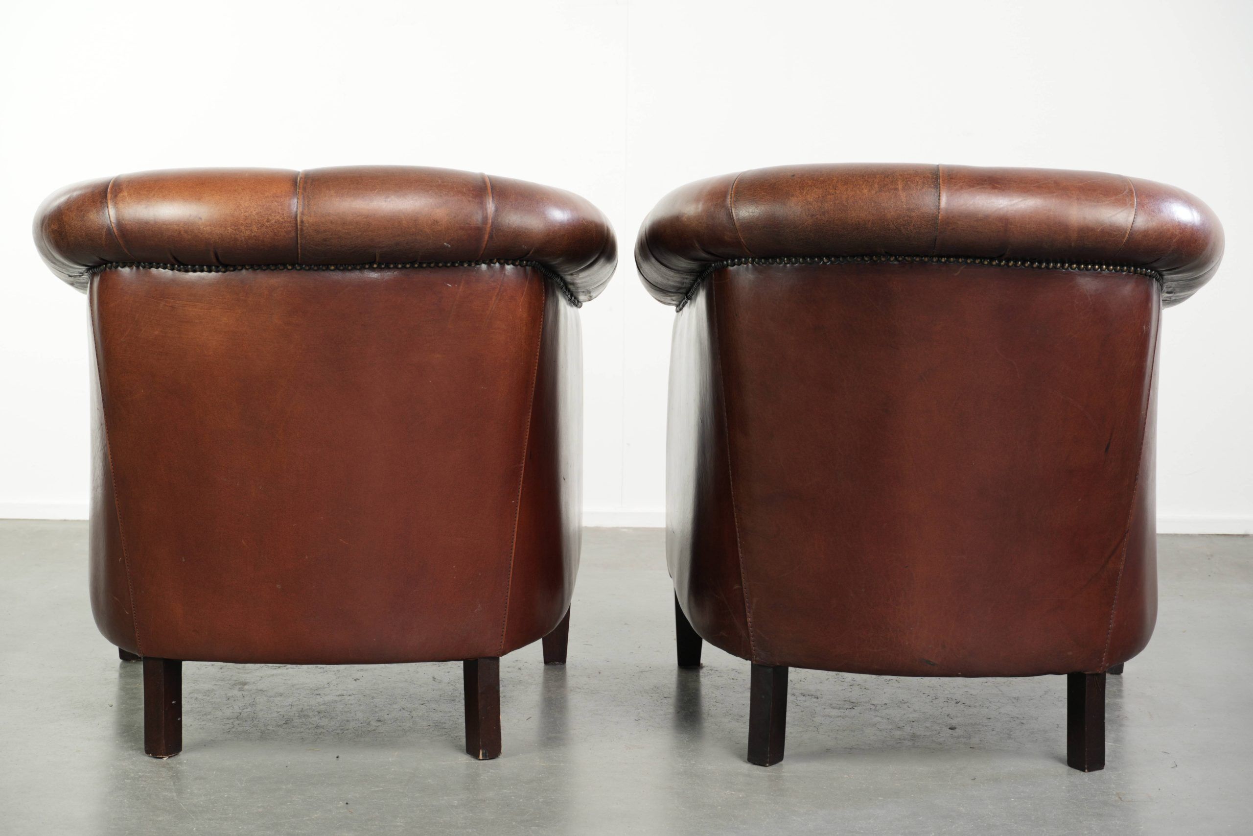 Characterful set of sheepskin club armchairs in English chesterfield style