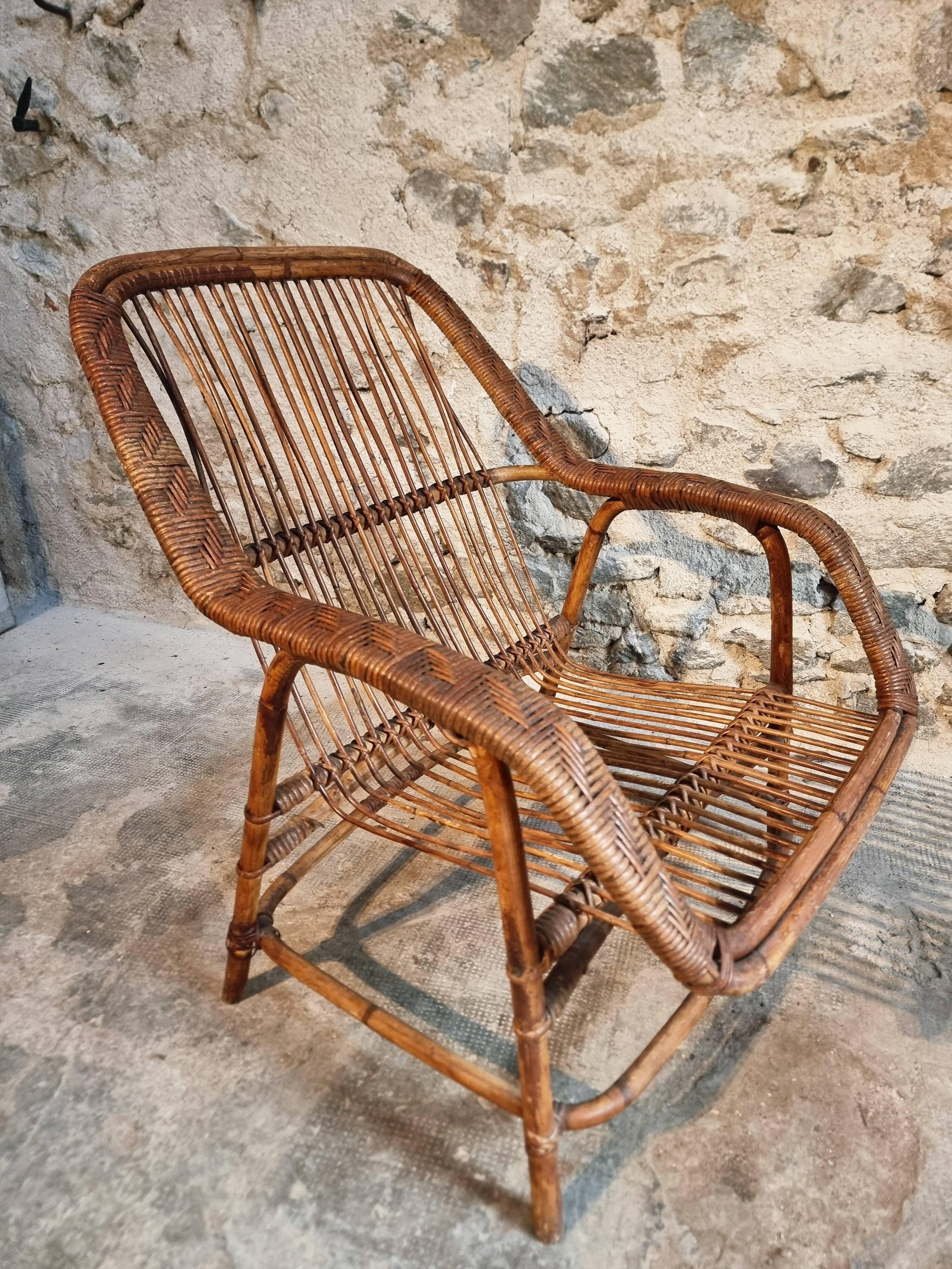Vintage rattan lounge set, French wicker armchairs and round table, circa 1930–1950.