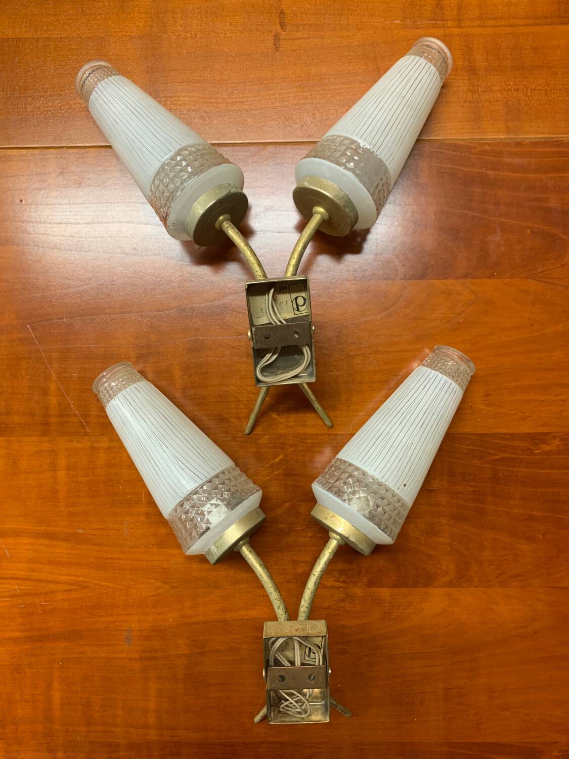 Pairs of brass sconces, ear-shaped tulips in opaline glass from the 1950s