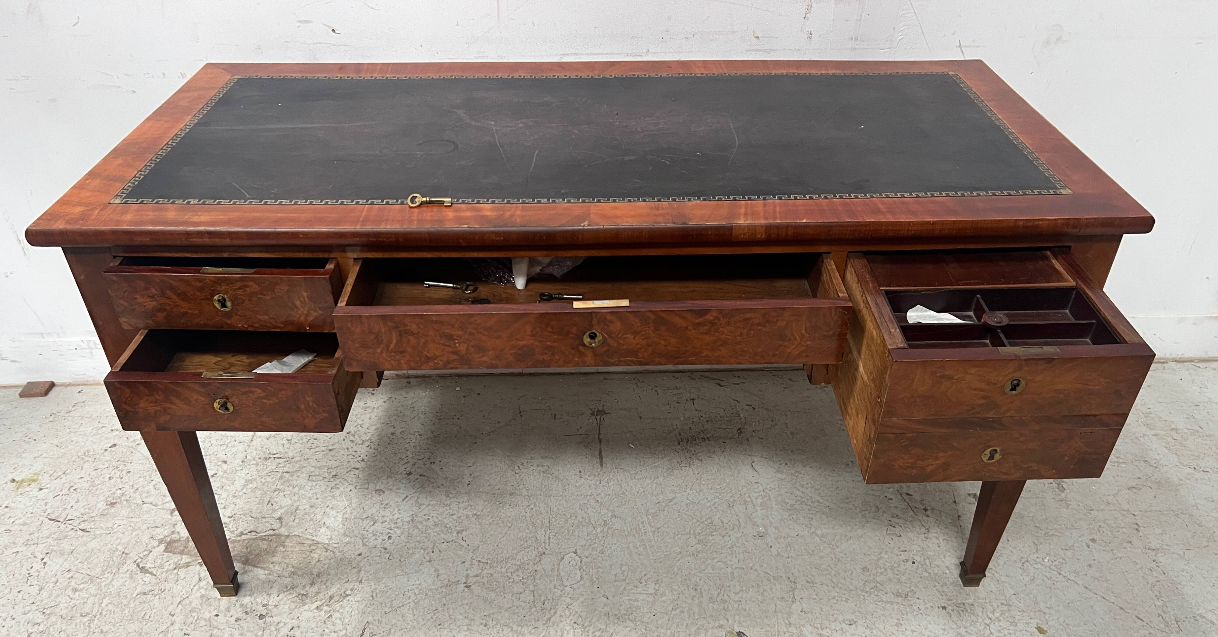 Louis XVI style flat desk in walnut and veneer, 19th century.