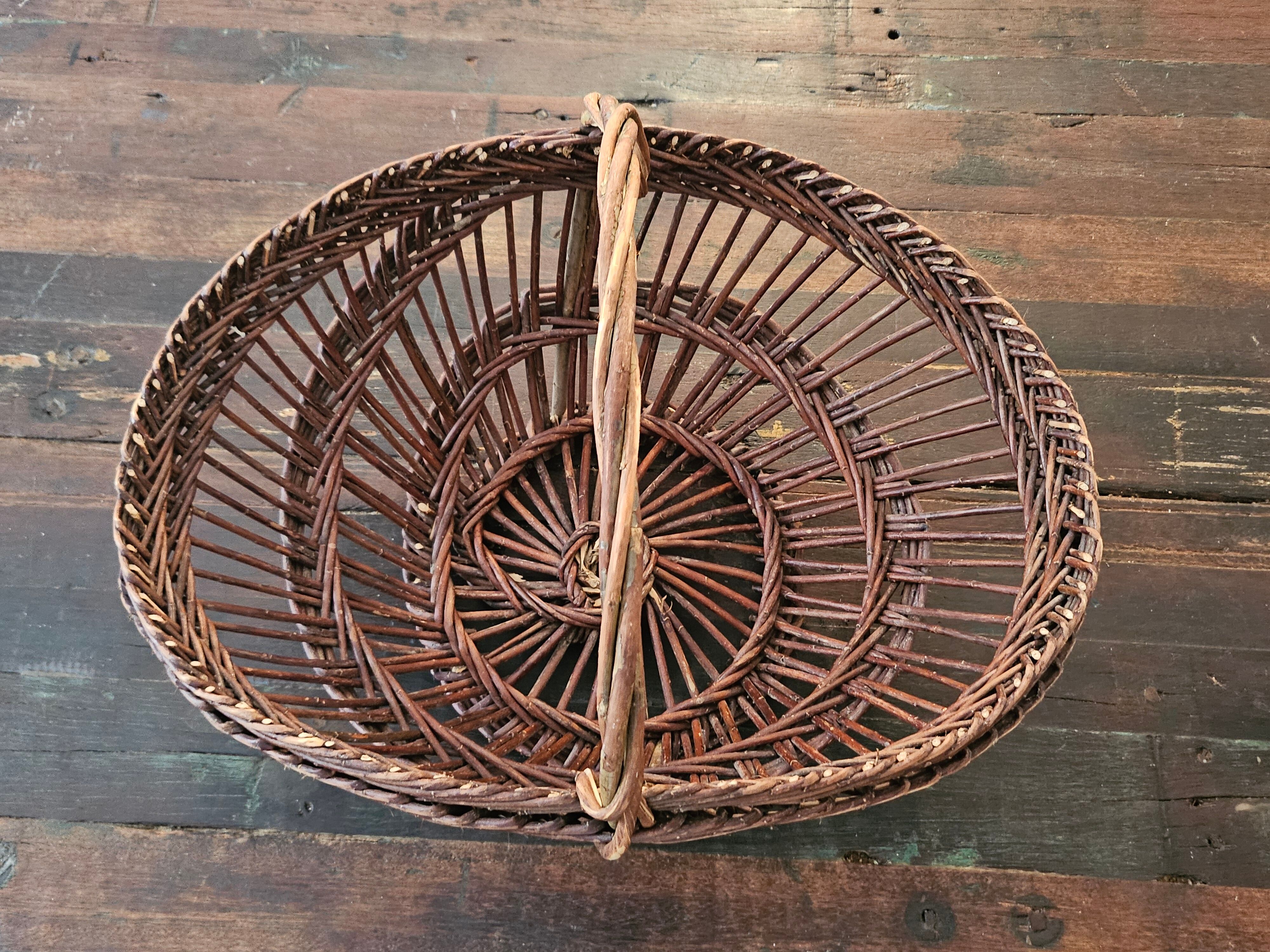 Vintage wicker basket with openwork, sun weaving and large handle.