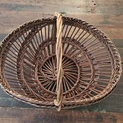Vintage wicker basket with openwork, sun weaving and large handle.