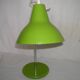 Green desk lamp with an arm from the 1970s.
