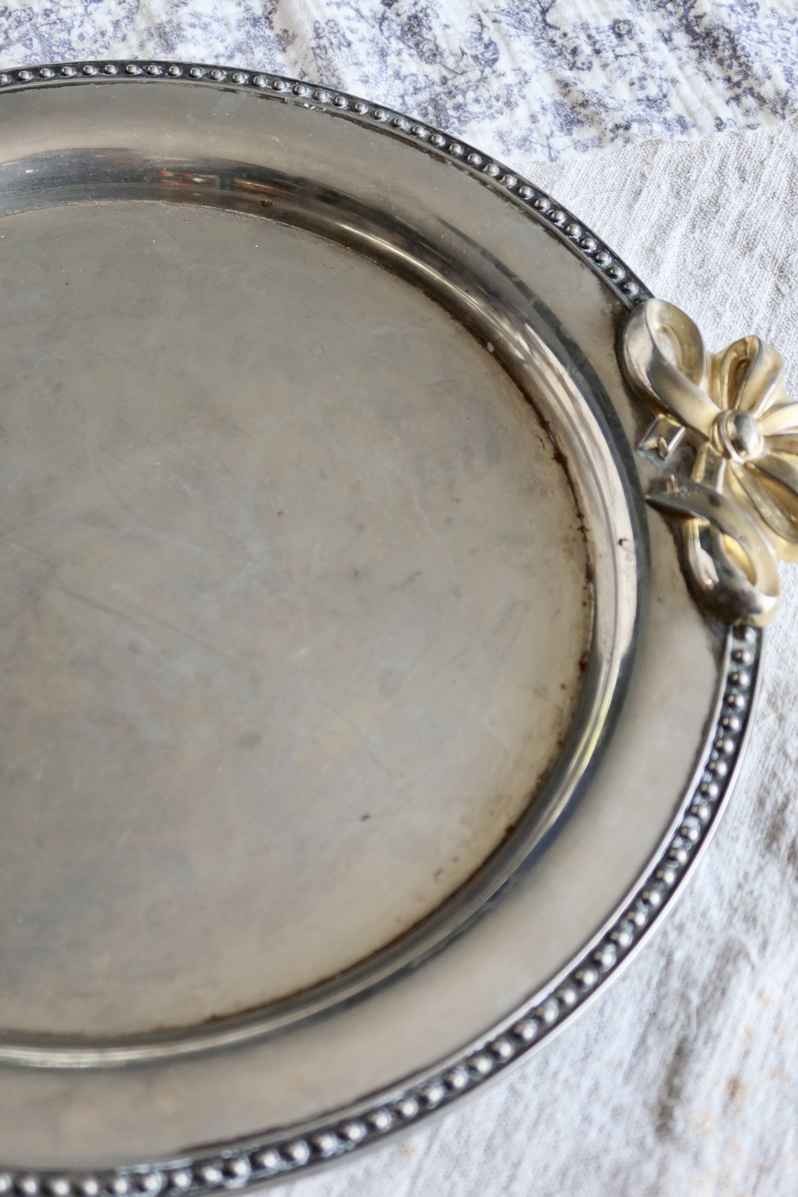 Vintage round silver metal serving tray with gold knot handles
