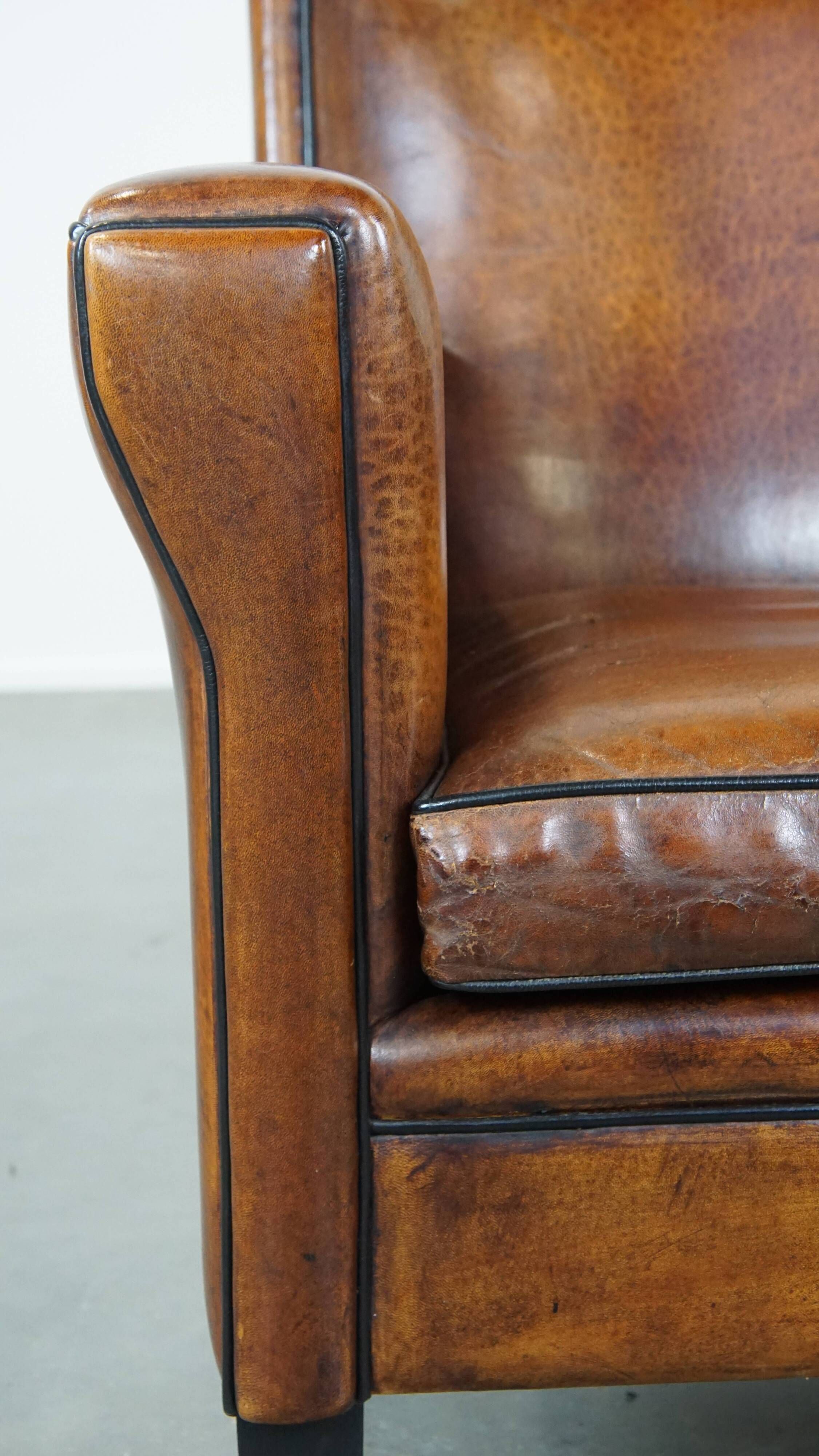 Cognac-colored sheep leather Art Deco design armchair finished with piping
