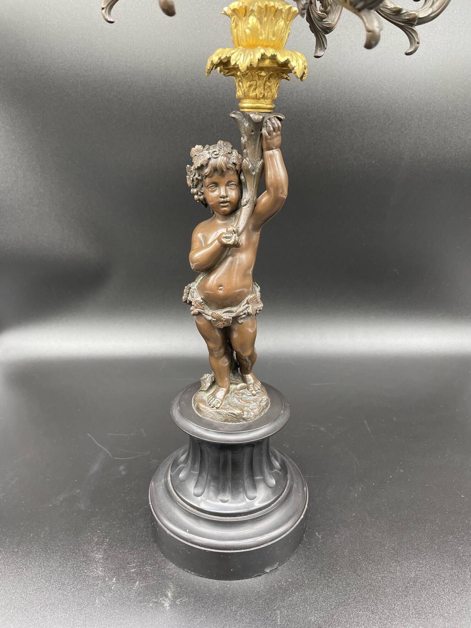 Candelabra with cherub in patinated bronze