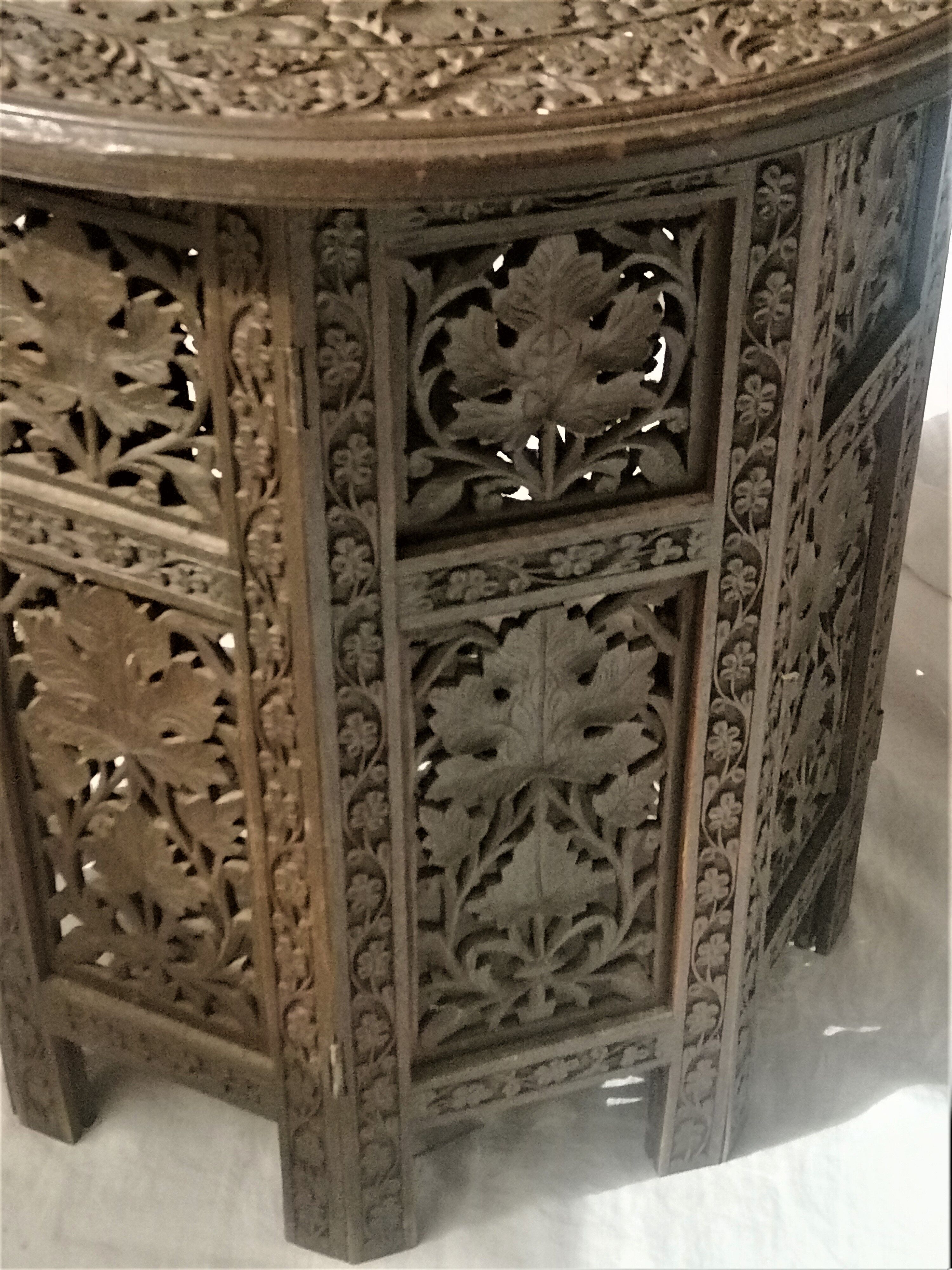Ancient oriental pedestal table in carved wood