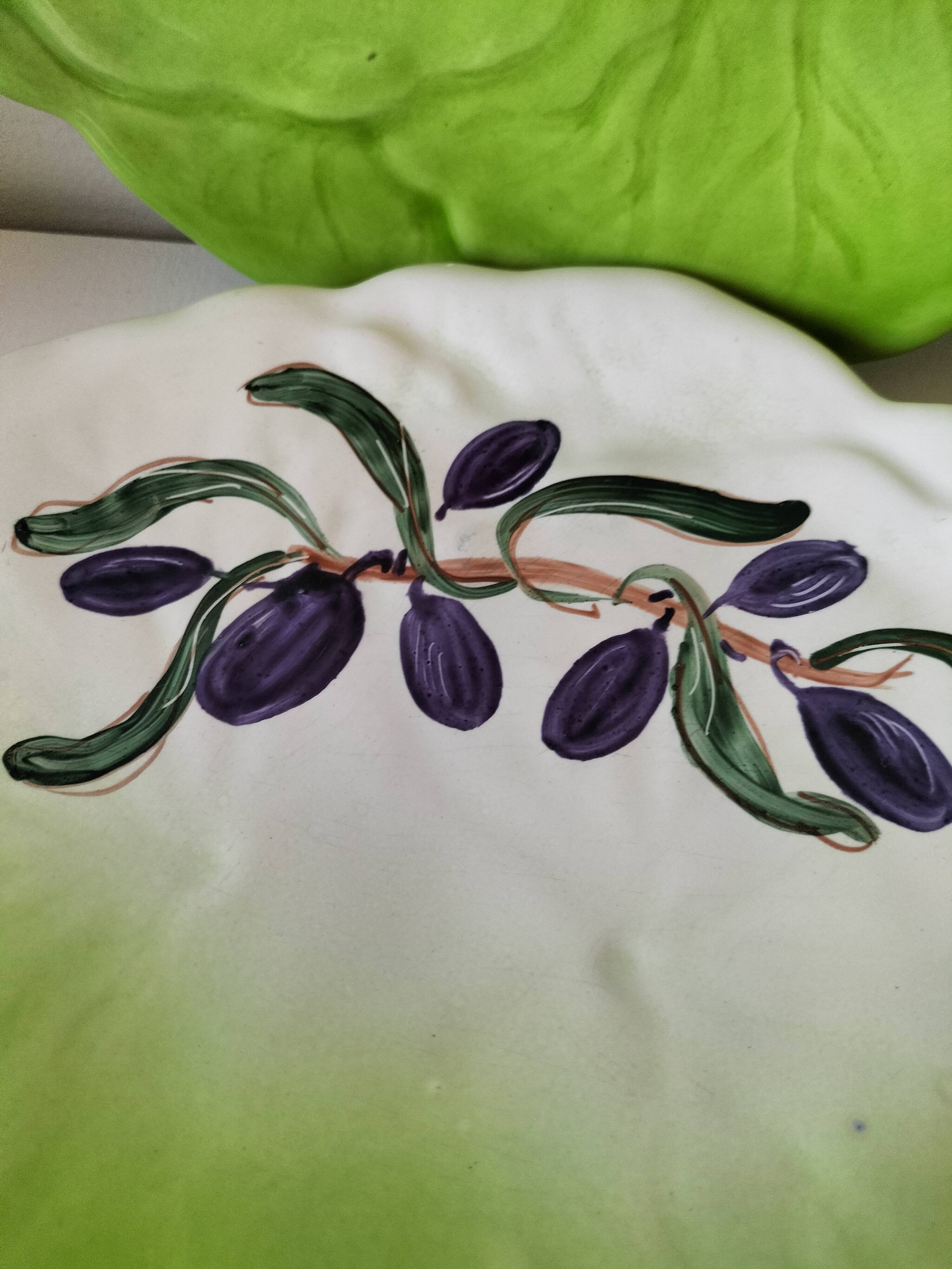 4 hand-decorated earthenware plates with vegetable and green leaf designs.