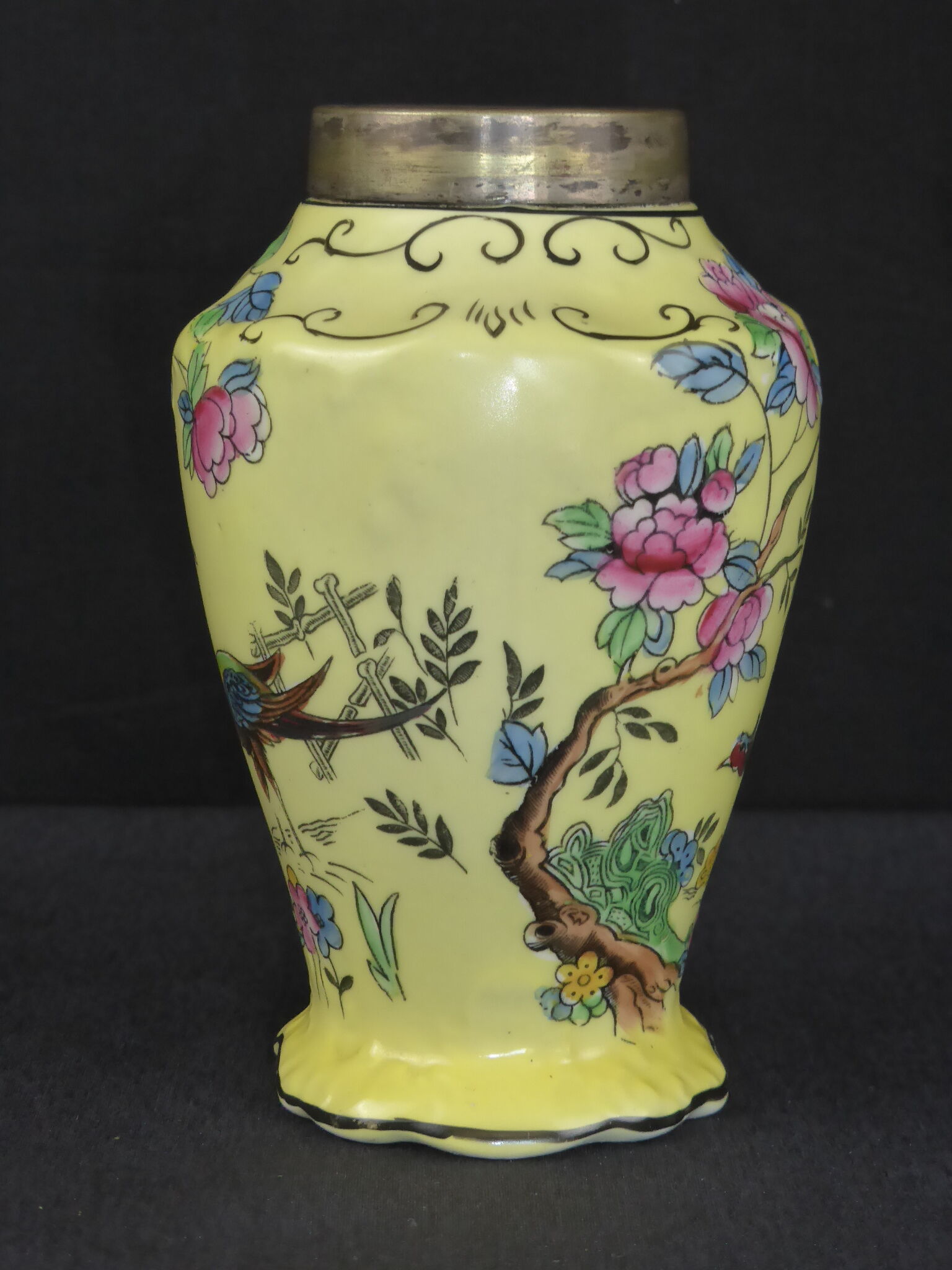 Old yellow ceramic vase decorated with flowers and a pheasant