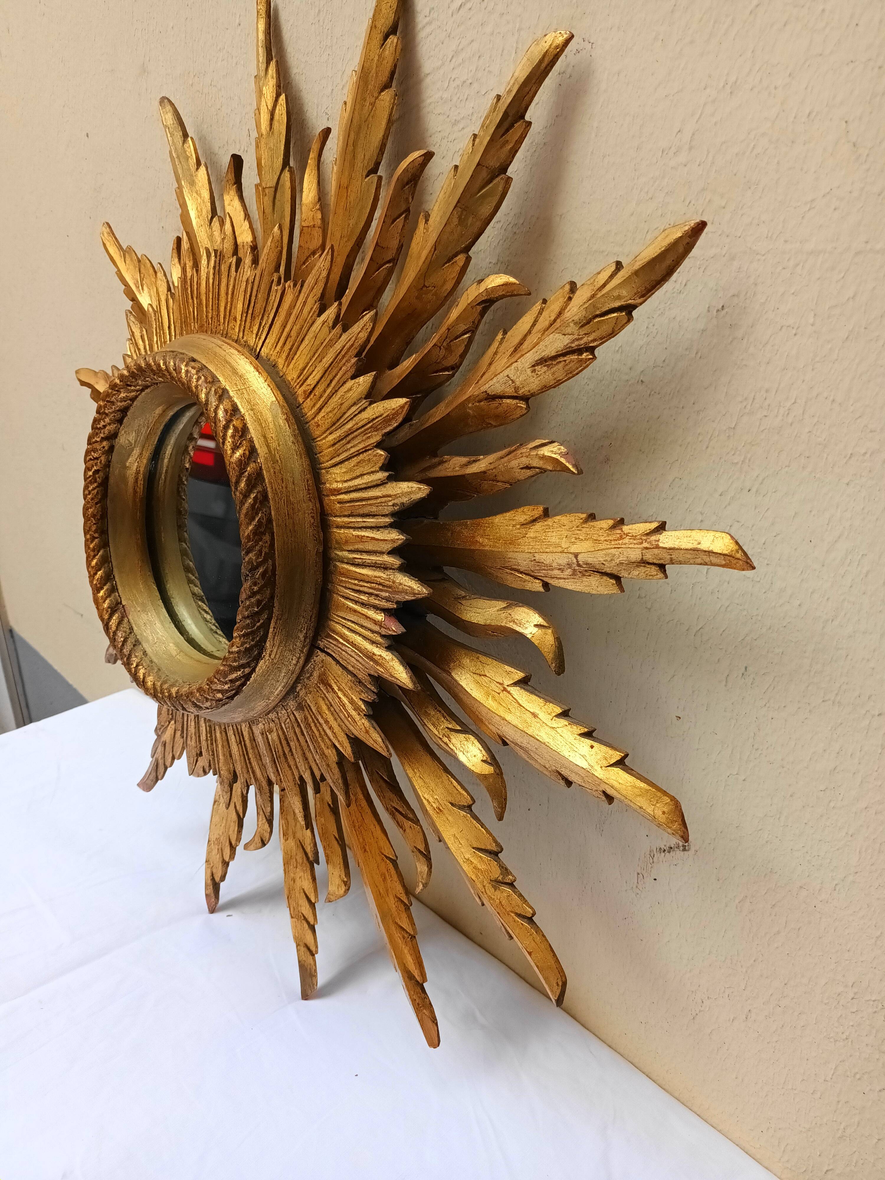 Sun mirror in carved gilded wood from the 1950s