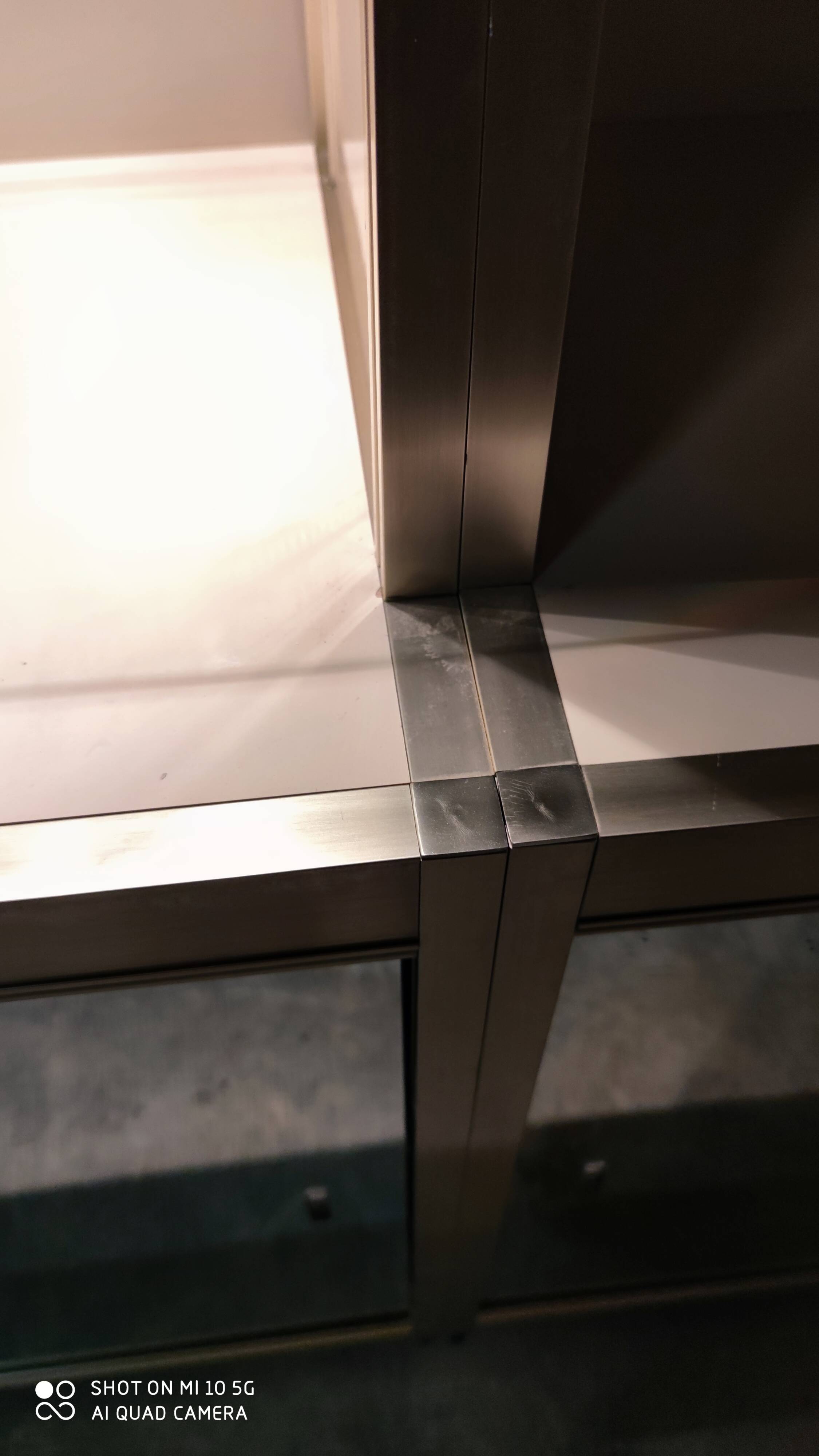 Ivory-colored and matte gold anodized aluminum display bookcase