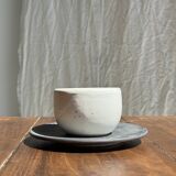 White Indonesian ceramic cup and gray saucer