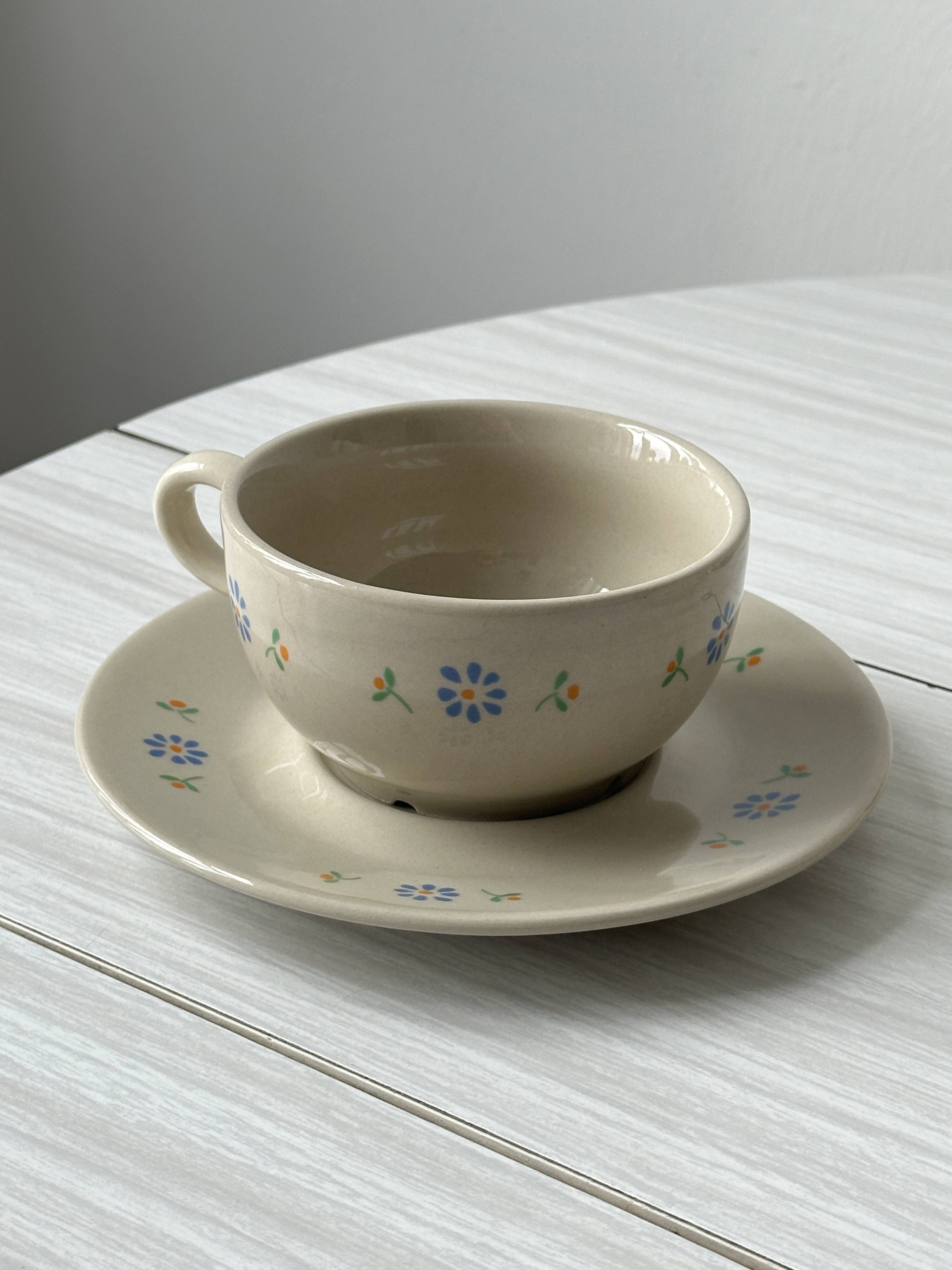 Ceramic cups and saucers with flower decoration