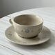 Ceramic cups and saucers with flower decoration