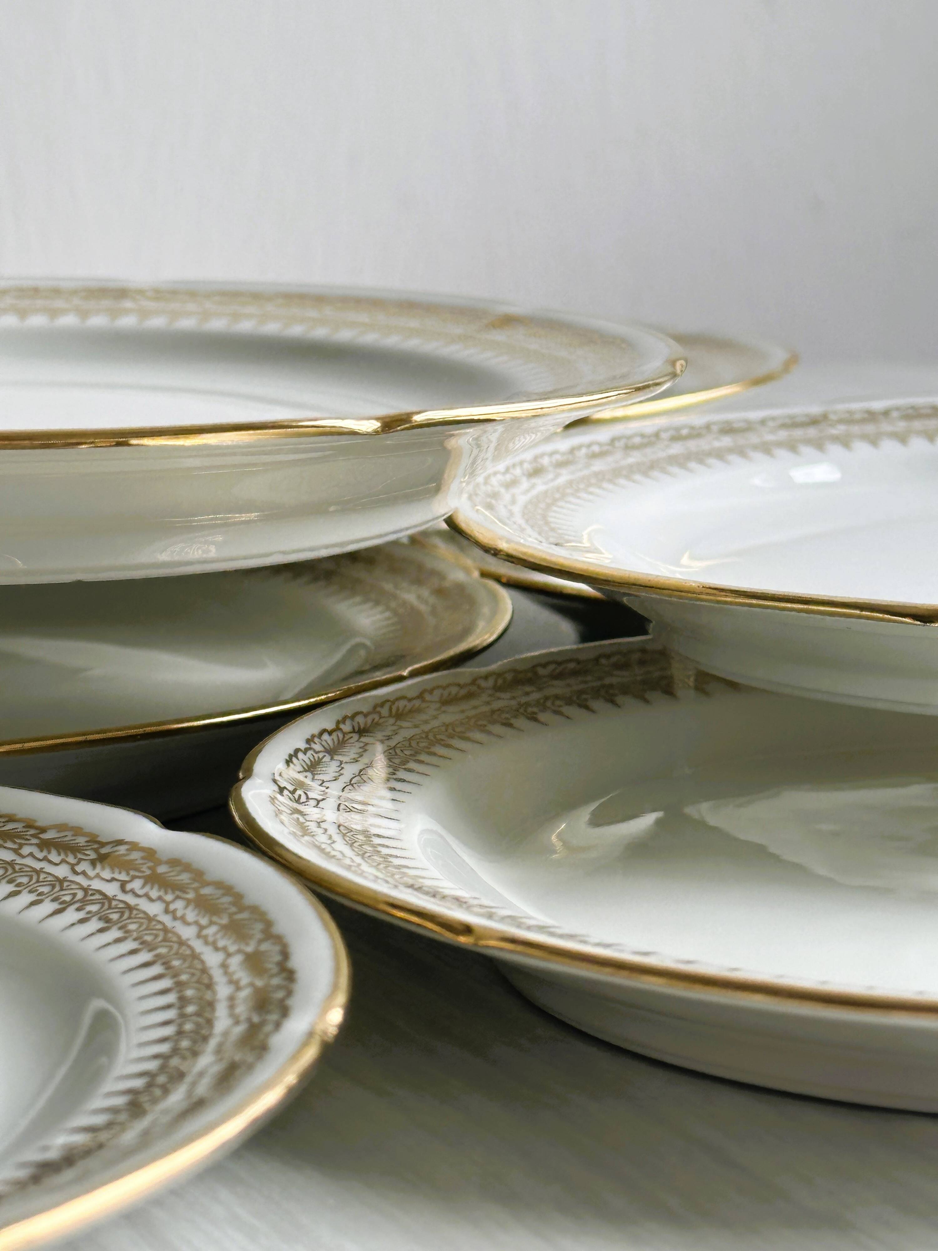 12 Limoges porcelain dessert plates, gold decoration.
