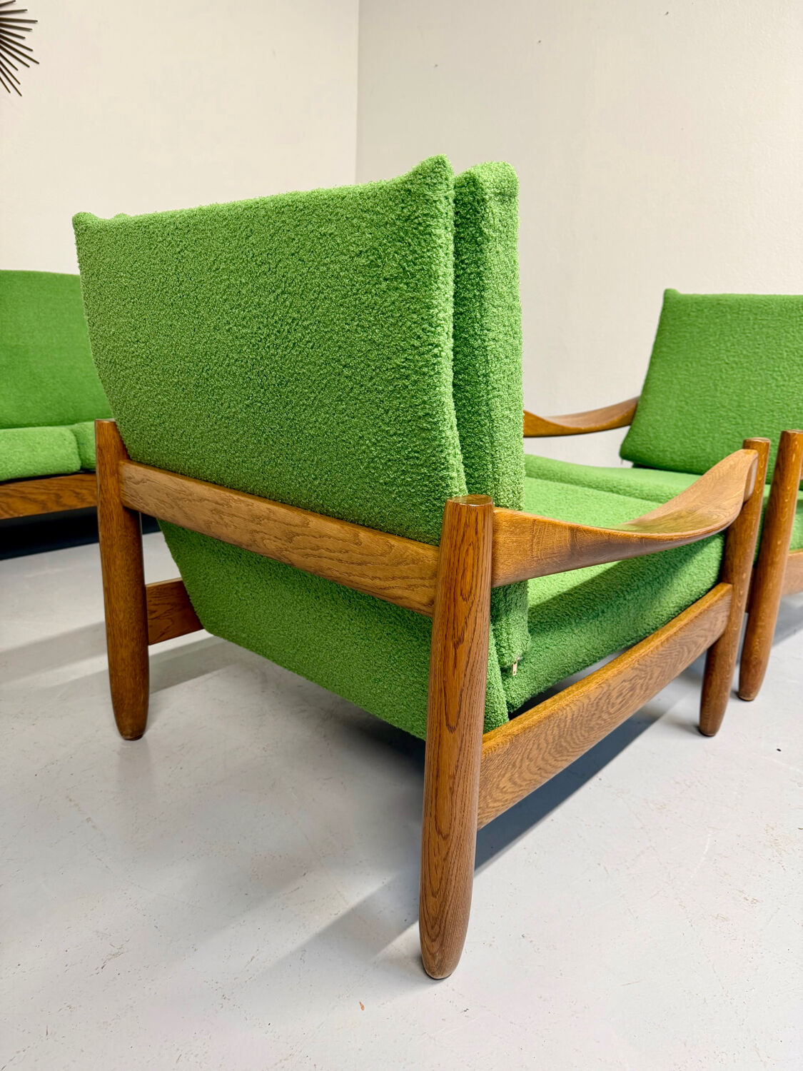 Living room sofa and Scandinavian design armchairs from the 1960s in green boucle.