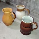 Set of three glazed stoneware pitchers